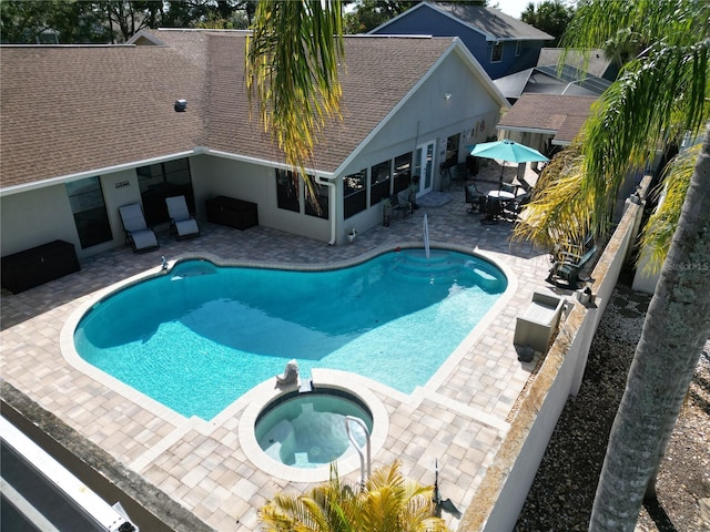 view of swimming pool featuring a patio area and a pool with connected hot tub