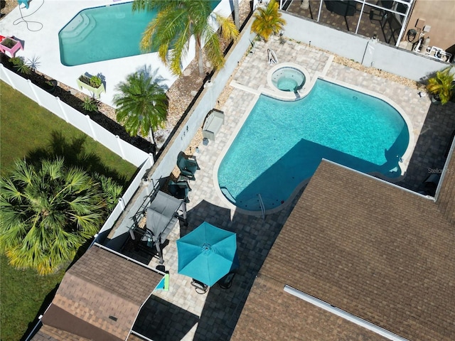 view of pool featuring an in ground hot tub, a fenced backyard, a fenced in pool, and a patio