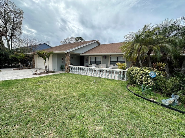single story home featuring a front lawn, covered porch, concrete driveway, an attached garage, and stucco siding