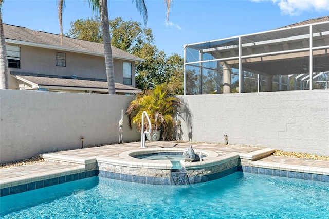 outdoor pool featuring glass enclosure, an in ground hot tub, and fence