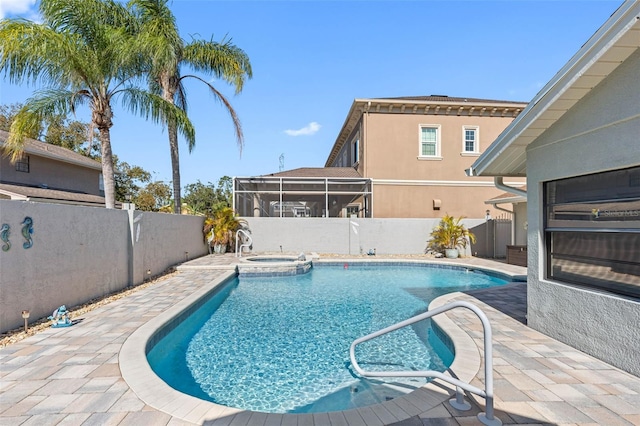 view of swimming pool featuring a fenced backyard, a sunroom, a pool with connected hot tub, and a patio