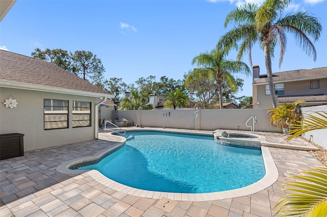 view of pool featuring a patio area, a pool with connected hot tub, and fence