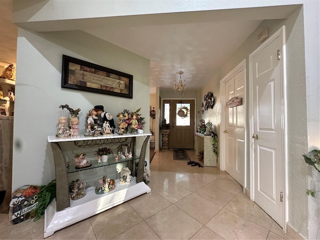 foyer entrance with a chandelier and light tile patterned floors