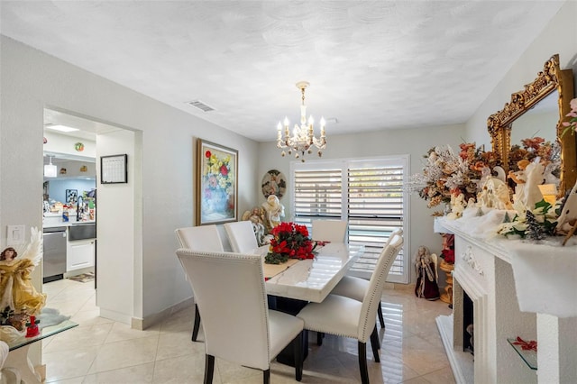 dining room featuring baseboards, a notable chandelier, visible vents, and light tile patterned floors