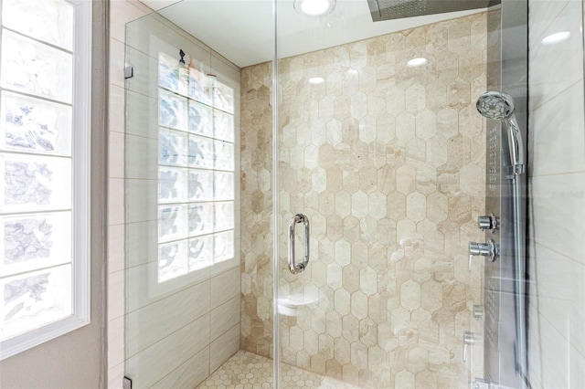 bathroom featuring a stall shower and a healthy amount of sunlight