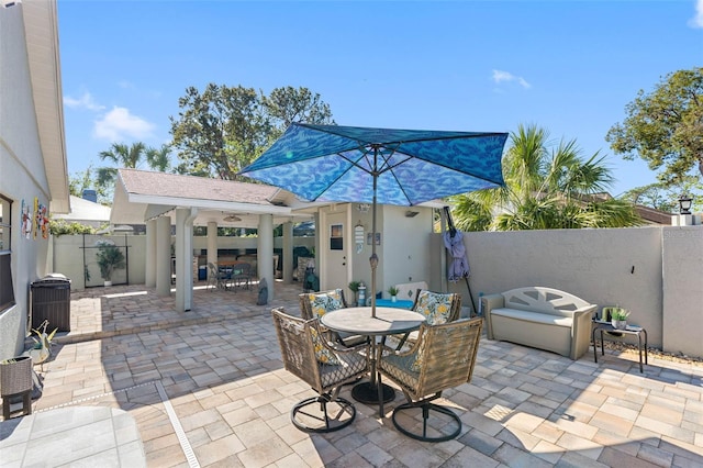 view of patio featuring outdoor dining area, cooling unit, and a fenced backyard