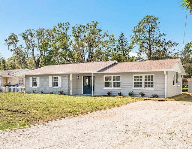 ranch-style home featuring a front yard