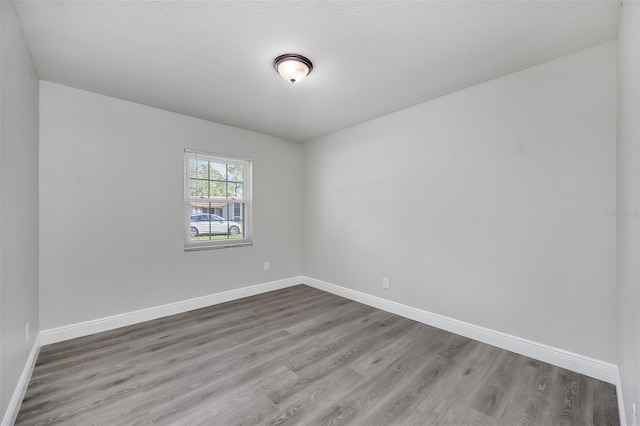 unfurnished room with hardwood / wood-style flooring