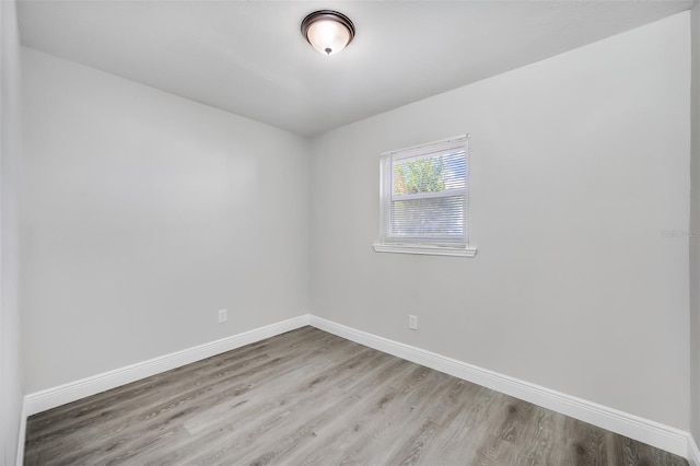 empty room with light hardwood / wood-style flooring