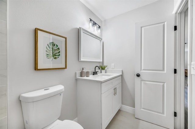 bathroom with vanity, toilet, and tile patterned flooring