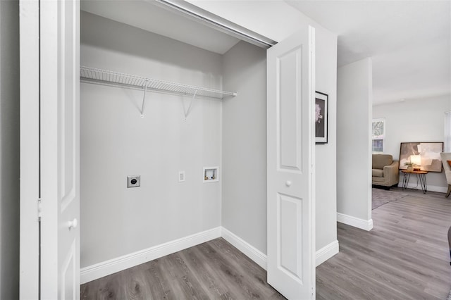 clothes washing area with hookup for an electric dryer, hardwood / wood-style flooring, and washer hookup