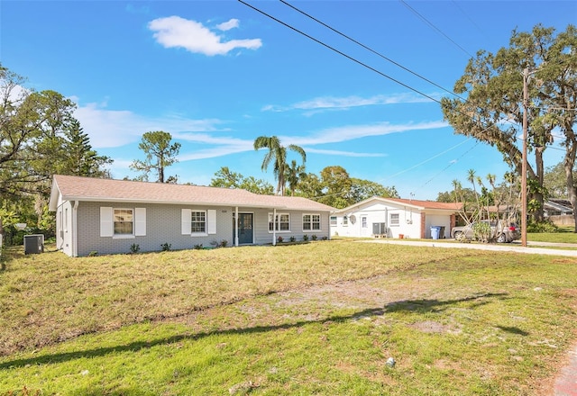 ranch-style home featuring central air condition unit and a front yard