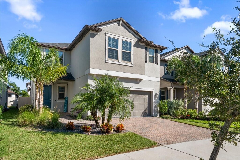 view of front of house featuring a garage and a front lawn