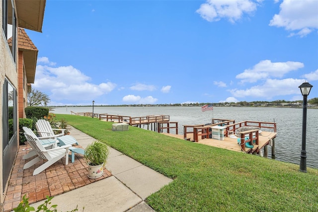 dock area featuring a water view and a yard