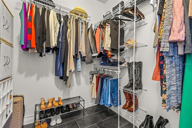 spacious closet featuring dark tile patterned floors