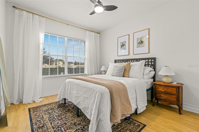 bedroom featuring light wood-type flooring and ceiling fan