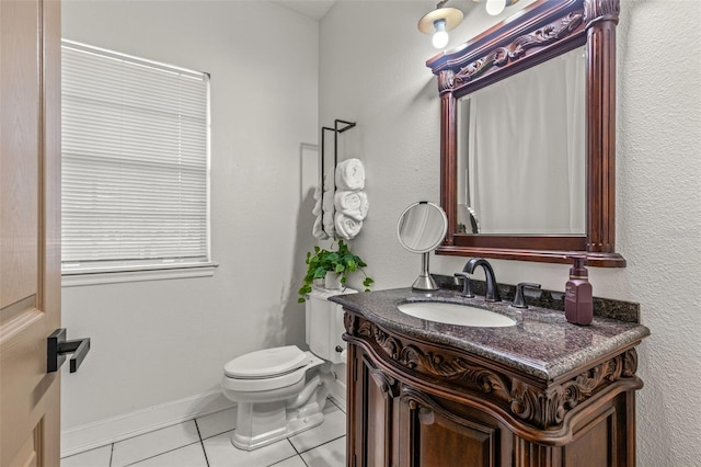 bathroom featuring vanity, toilet, and tile patterned flooring