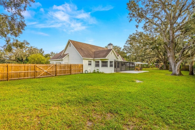 rear view of property with a lawn and a sunroom