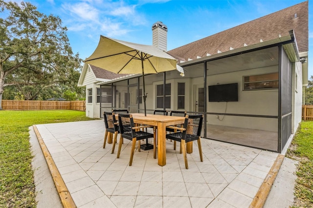 view of patio featuring a sunroom