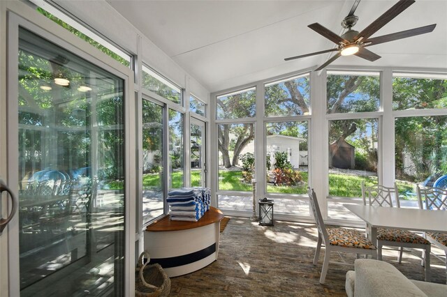 sunroom / solarium with wood finished floors and vaulted ceiling