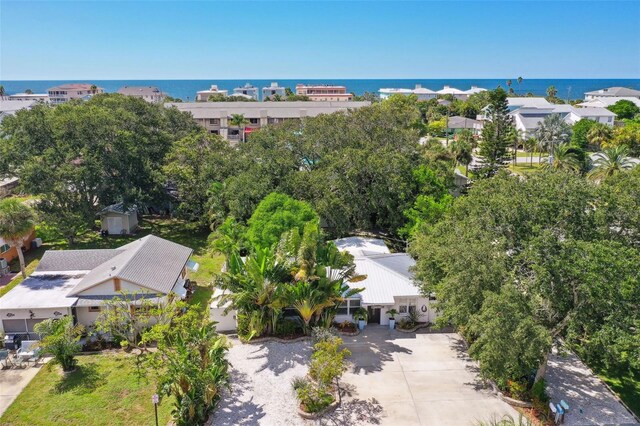 aerial view of property and surrounding area with a nearby body of water