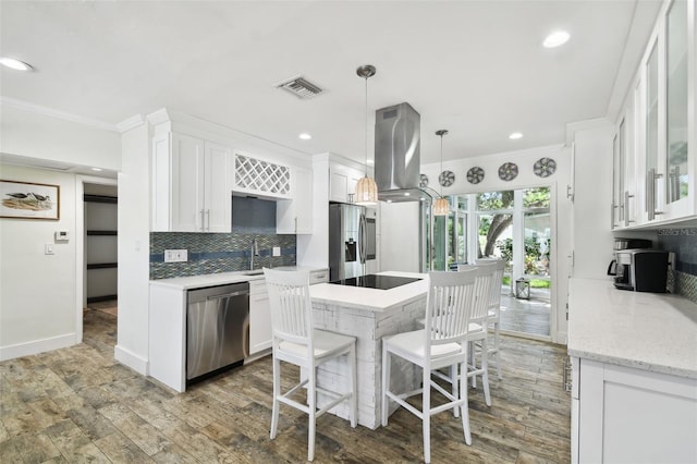 kitchen featuring a kitchen island, visible vents, white cabinetry, appliances with stainless steel finishes, and island exhaust hood