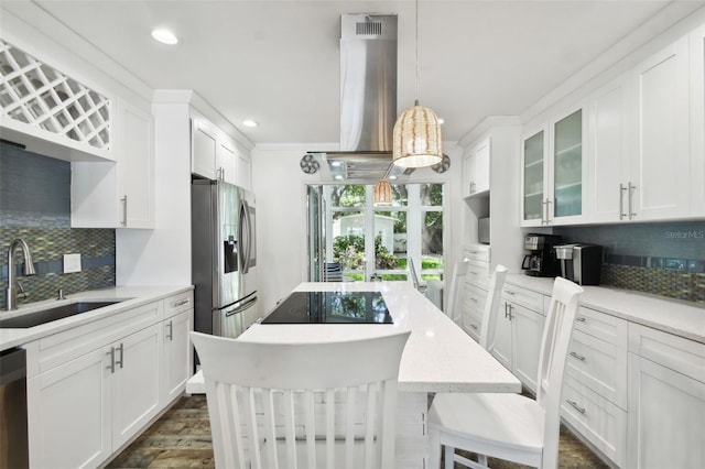 kitchen with stainless steel appliances, backsplash, glass insert cabinets, white cabinetry, and a sink