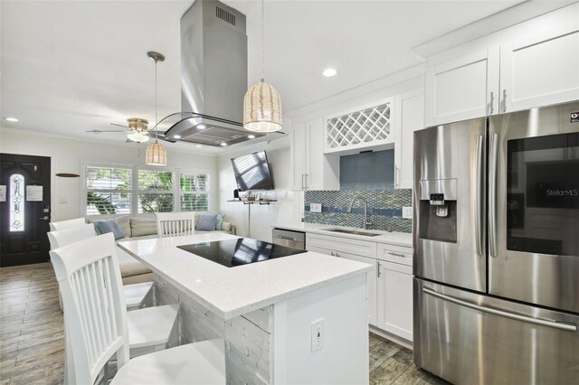 kitchen featuring a center island, island exhaust hood, stainless steel appliances, white cabinetry, and a sink