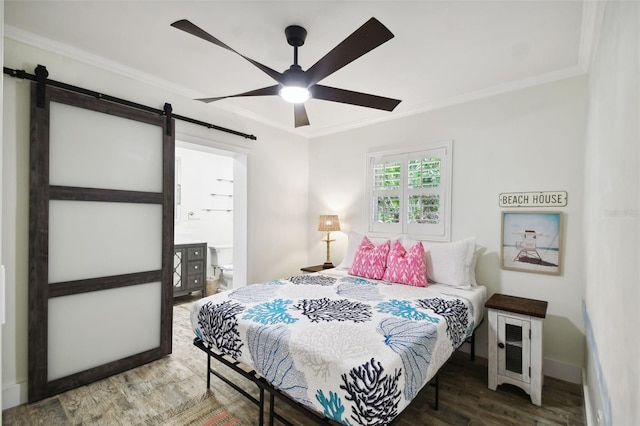 bedroom with a ceiling fan, a barn door, ornamental molding, and wood finished floors