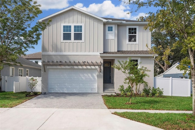 view of front of home featuring a garage and a front yard