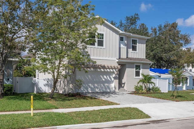 view of front of property featuring a garage and a front lawn