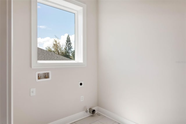 laundry area with light tile patterned flooring, hookup for an electric dryer, and hookup for a washing machine