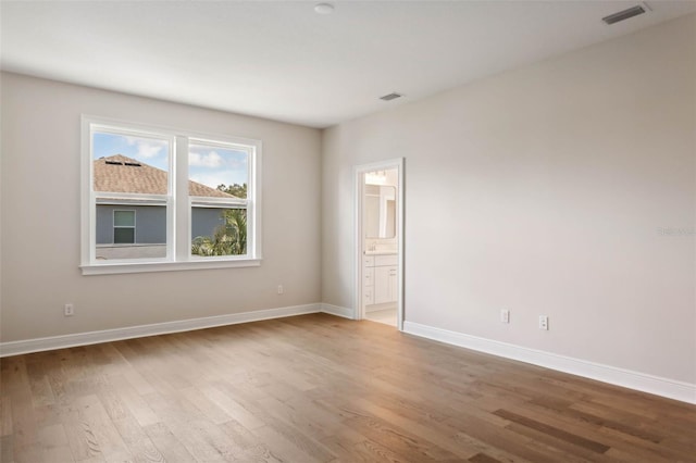 spare room featuring light hardwood / wood-style flooring