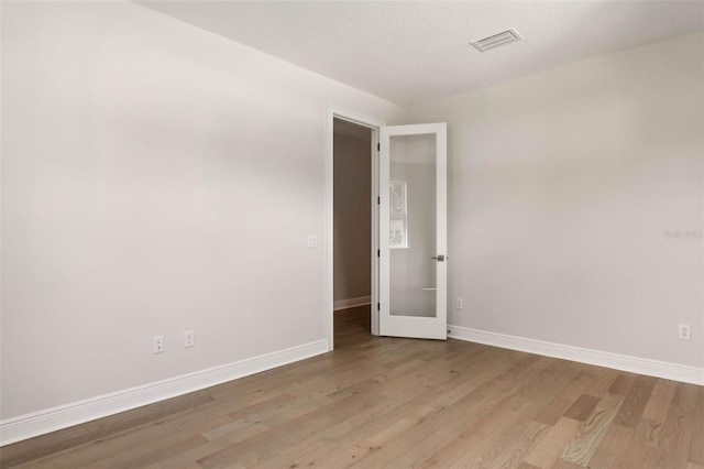 empty room with light hardwood / wood-style floors