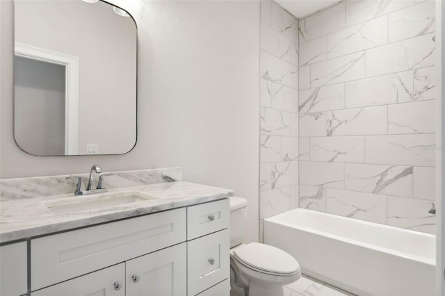 full bathroom featuring tiled shower / bath, vanity, and toilet