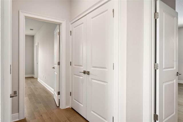 corridor with light wood-type flooring