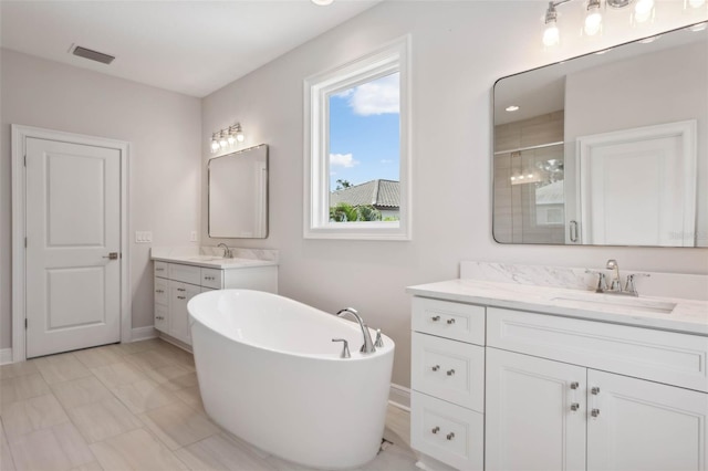 bathroom featuring vanity and independent shower and bath