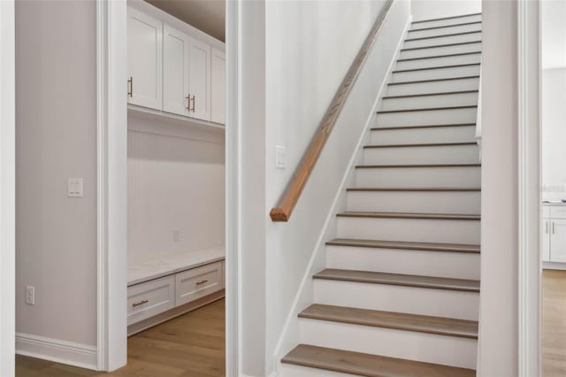 stairs featuring wood-type flooring