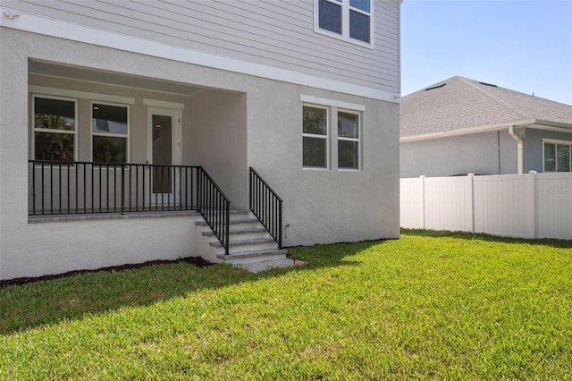 doorway to property featuring a lawn