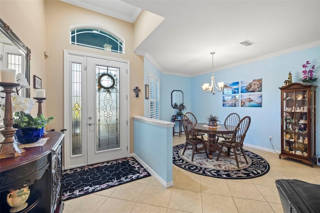 tiled foyer entrance featuring crown molding and a notable chandelier