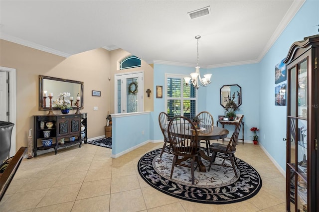 tiled dining room featuring a notable chandelier and ornamental molding