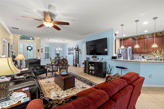 tiled living room featuring ornamental molding and ceiling fan with notable chandelier