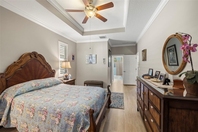 bedroom featuring ceiling fan, ornamental molding, multiple windows, and light wood-type flooring