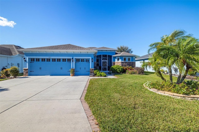 prairie-style home featuring stucco siding, a front yard, concrete driveway, and an attached garage