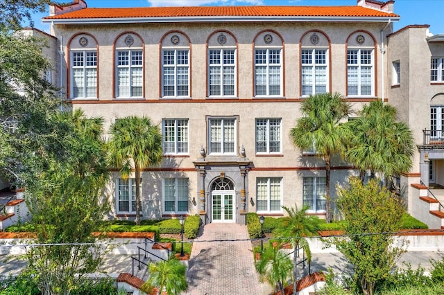 mediterranean / spanish-style home with french doors