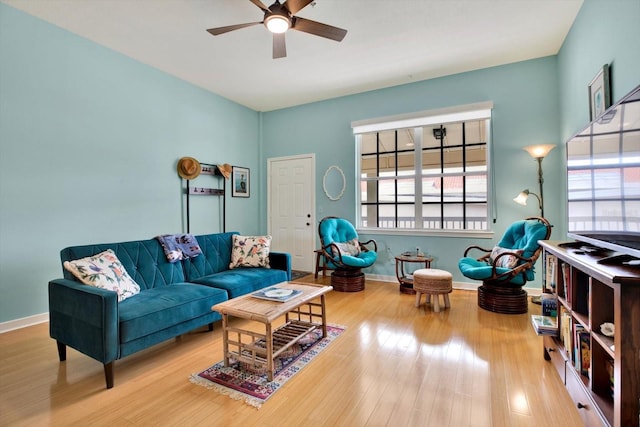 living room featuring ceiling fan and wood-type flooring