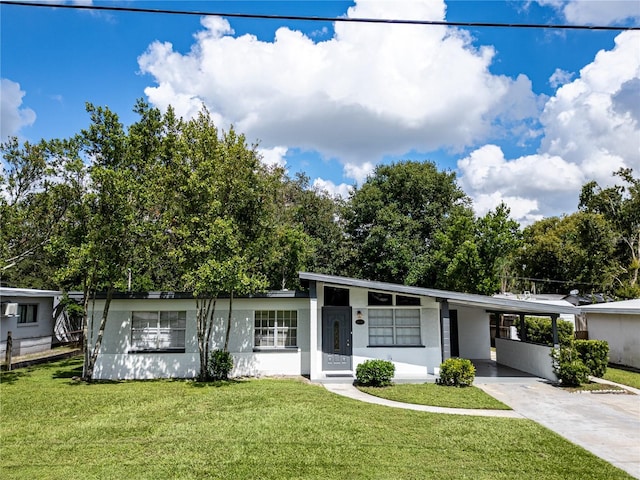 single story home with a front yard and a carport