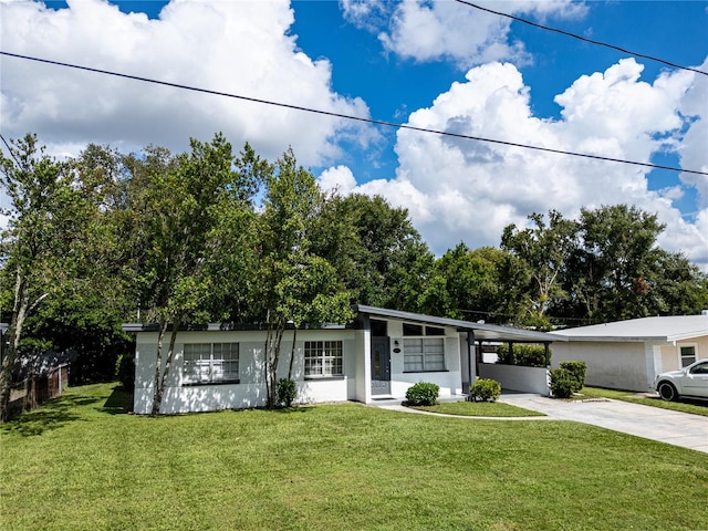 ranch-style home with a carport and a front yard