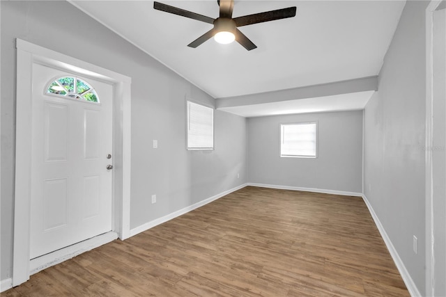 foyer entrance with lofted ceiling, light wood-type flooring, ceiling fan, and a healthy amount of sunlight