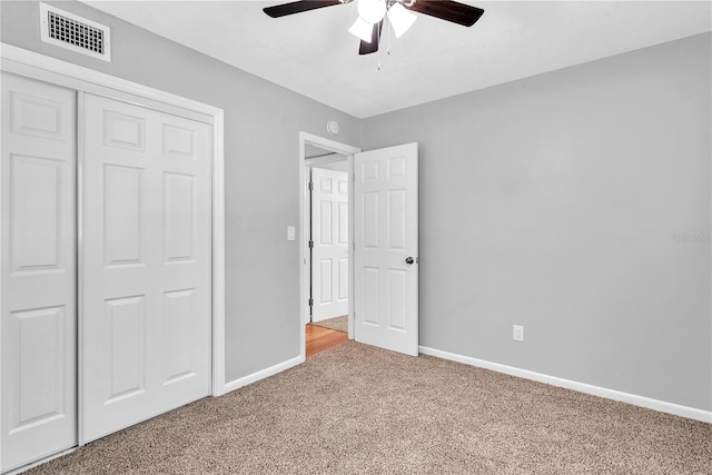 unfurnished bedroom with carpet, ceiling fan, and a closet